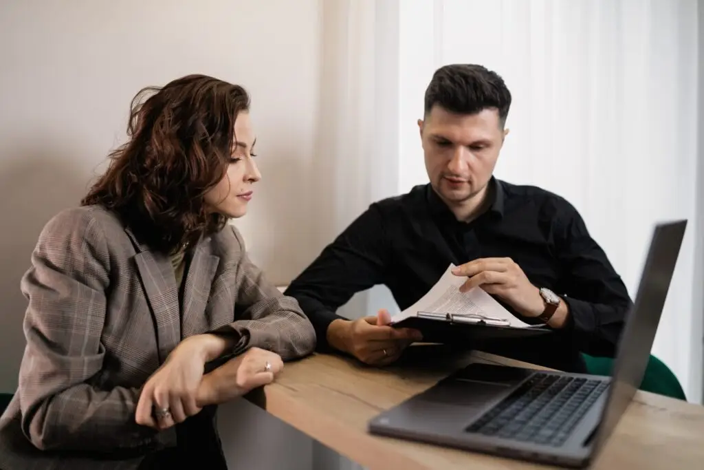 woman gets papers reviewed by agent scaled