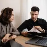woman gets papers reviewed by agent scaled