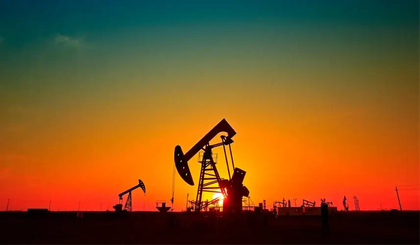 Silhouetted oil pump jacks at sunset, highlighting the importance of royalty rights in Texas