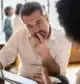 A potential mineral rights seller reviews offer terms with a consultant, illustrating the importance of understanding buyer constraints.