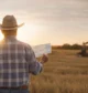 Texas landowners reviewing a mineral rights offer while standing near an oil pumpjack, illustrating how mineral rights values can vary by location and activity